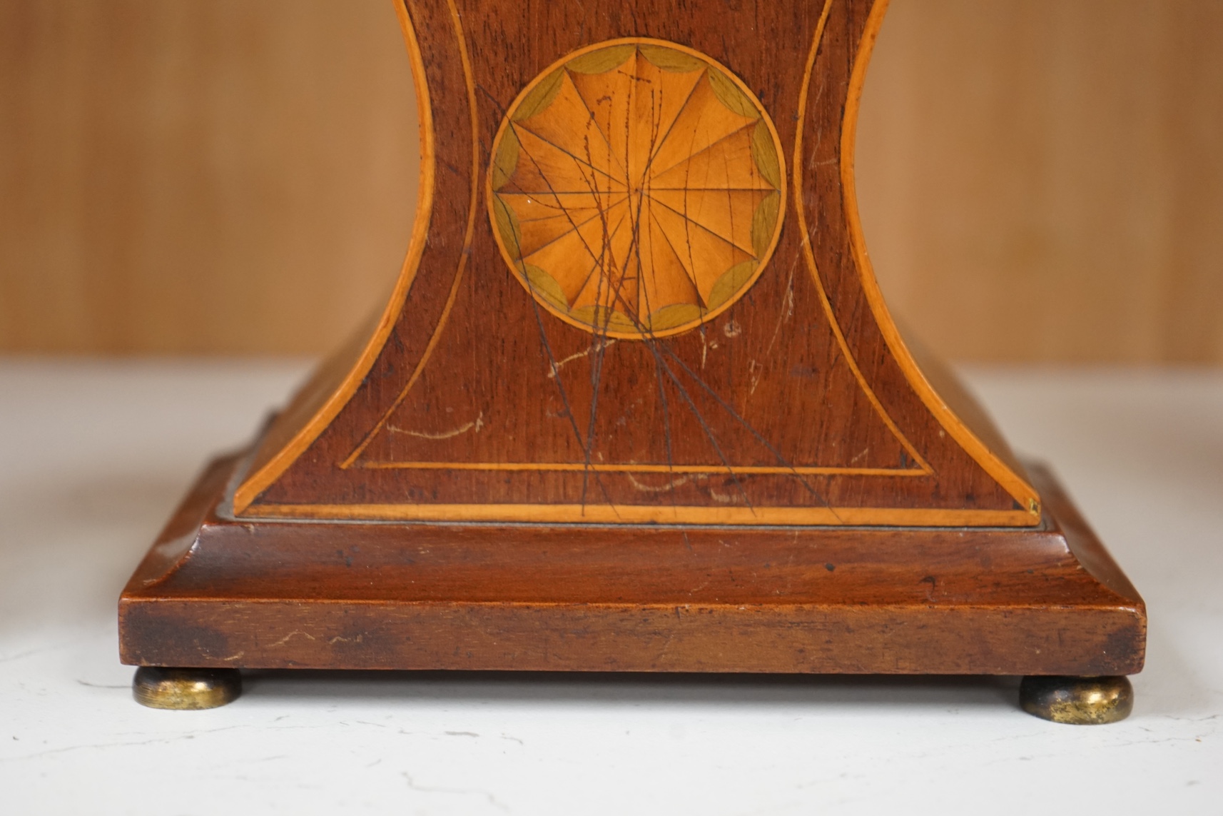 An Edwardian inlaid mahogany balloon clock and a brass cased carriage timepiece, largest 23cm high. Condition - fair, untested